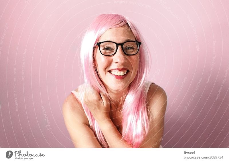 woman with pink wig smiling happily on pink background Lifestyle Happy Human being Feminine Woman Adults Female senior Head Hair and hairstyles Face Eyes Nose