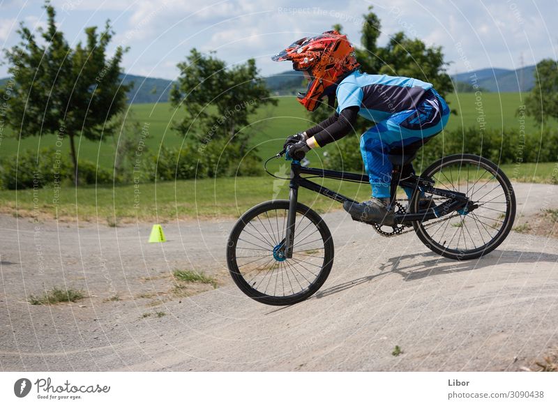 Boy riding on is bike Sports Cycling BMX bike Human being Child Boy (child) 1 Make Jump Athletic Colour photo Exterior shot Day