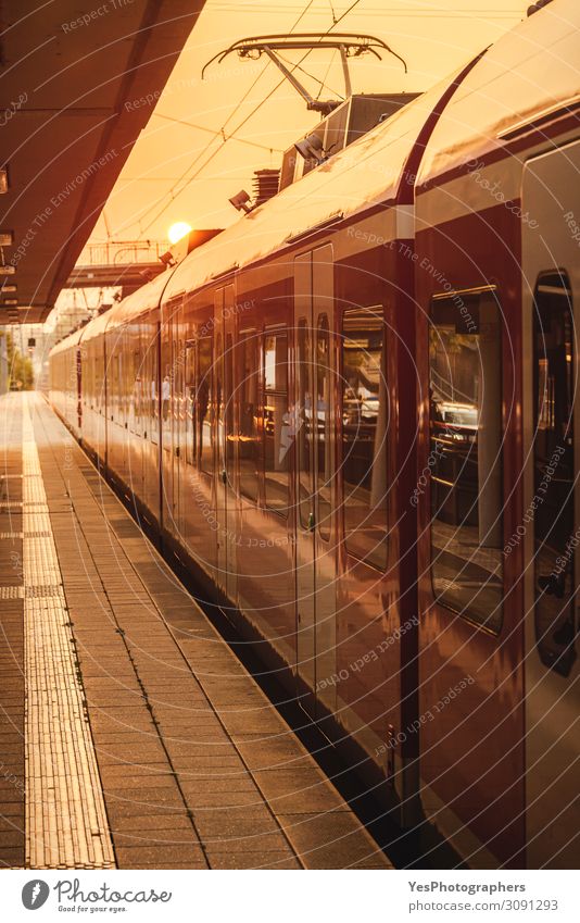 Passengers train in station at golden hour. Vacation & Travel Trip Train station Transport Means of transport Passenger traffic Public transit Train travel