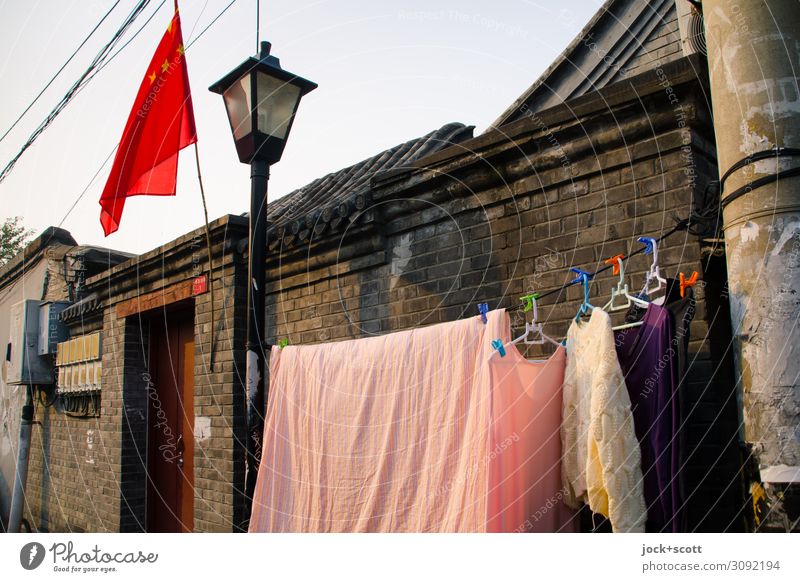 Washing day in Beijing Cinese architecture Wall (barrier) Main gate Laundry clothesline Flag Street lighting Hanger Brick Chinese Authentic Determination