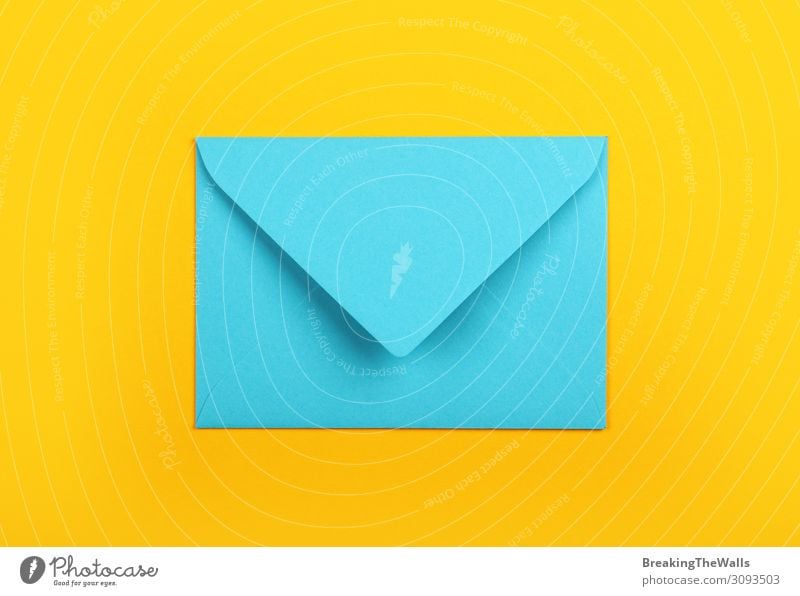 Closed blue paper envelope over yellow Office Mail Stationery Paper Modern Above Blue Yellow Colour Creativity pastel background post Communication Blank empty