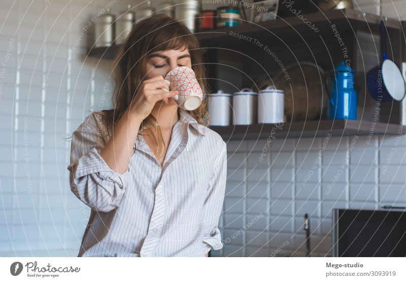 young woman drinking coffee at home Breakfast Beverage Coffee Tea Lifestyle Happy Beautiful Face Relaxation Leisure and hobbies House (Residential Structure)