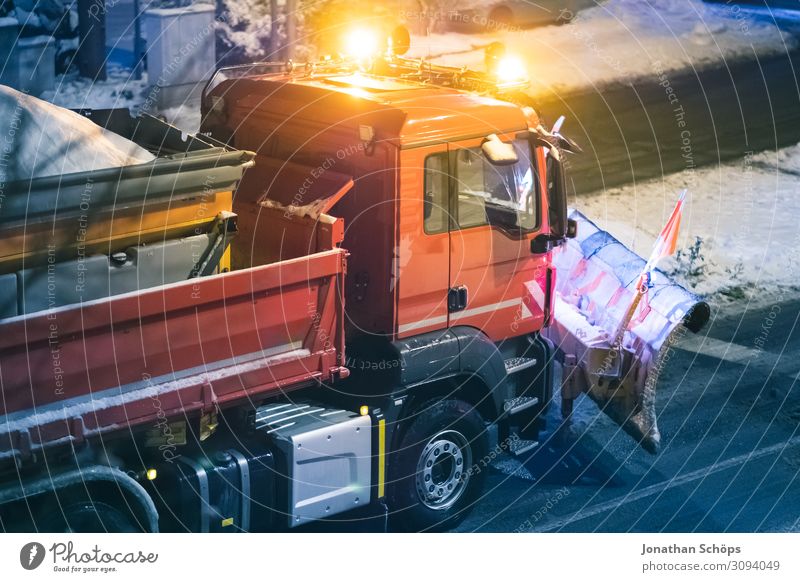Winter road clearance vehicle with snow plough on the road Snowfall Transport Traffic infrastructure Street Car Truck Cold Red Black ice Smoothness Seasons