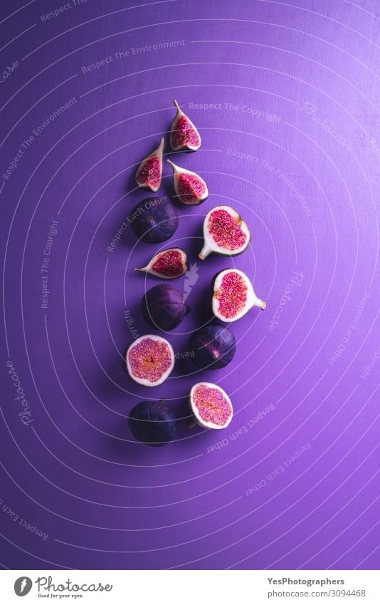 Fresh figs on a purple background. Sliced figs Vegetable Fruit Dessert Nutrition Vegetarian diet Diet Exotic Healthy Eating Delicious Juicy Violet Red