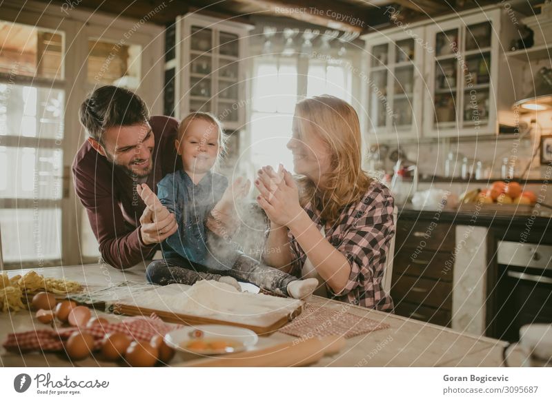 Happy family making pasta in the kitchen Joy Table Kitchen Child Human being Girl Woman Adults Man Family & Relations Infancy 3 Love Make Together Small