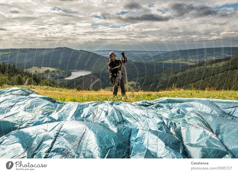 Sorting lines, paraglider makes preparations to take off Leisure and hobbies Sports Paragliding Pilot Masculine 1 Human being Landscape Water Sky Clouds Horizon