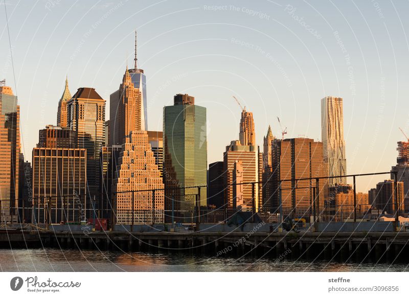 Downtown Manhattan at sunrise Cloudless sky Sunrise Sunset Autumn Beautiful weather Town Skyline Overpopulated High-rise Tourist Attraction Esthetic Dawn