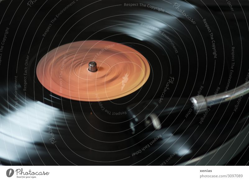 Record plays...and plays Record player Entertainment electronics Advancement Future Music Media Rotate Listening Old Dark Orange Black vintage Detail