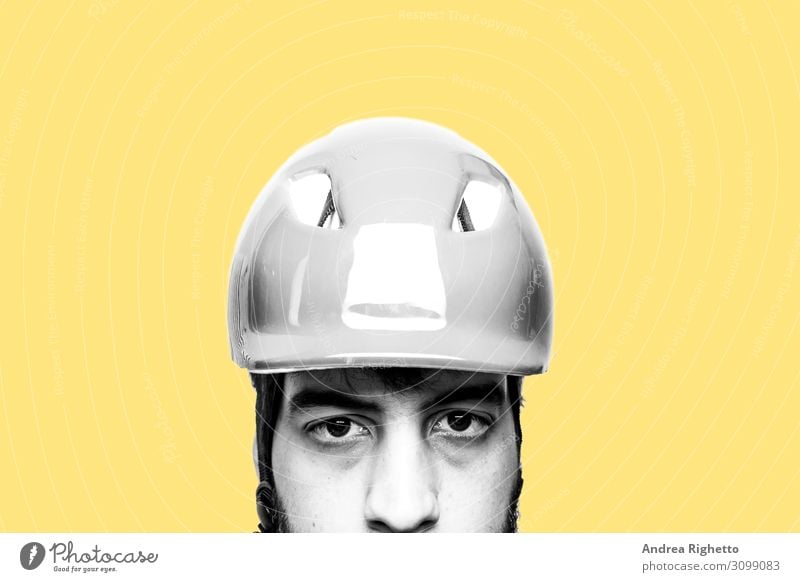 Concept of hating own job, stressed at work, unhappy of his job. Portrait of a sad, unhappy caucasian male factory worker wearing an helmet. Black and white subject with yellow background