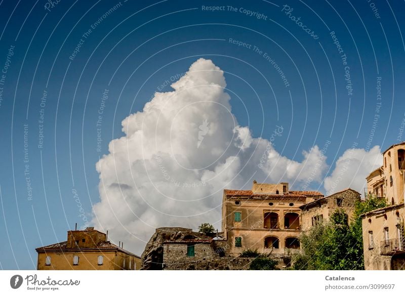 In the blue sky behind the old village a mountain of clouds is piled up Building houses Sky Clouds Village Architecture urban Facade Old Wall (building) Window
