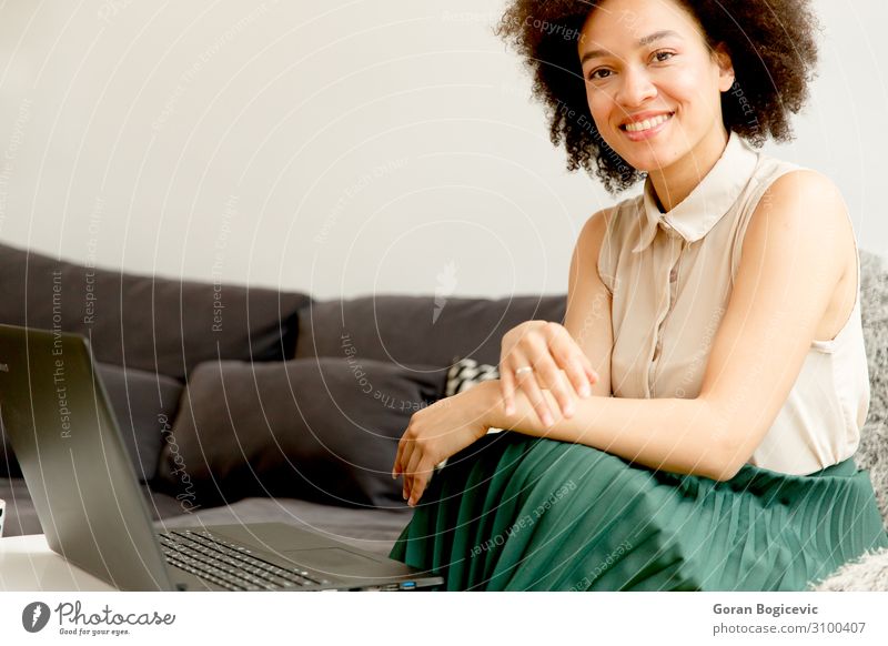 Young african american woman web-surfing internet Lifestyle Happy Beautiful Leisure and hobbies Sofa Computer Notebook Technology Telecommunications