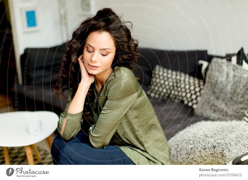 Portrait of a young woman with curly hair Lifestyle Beautiful Hair and hairstyles Flat (apartment) House (Residential Structure) Sofa Human being Feminine