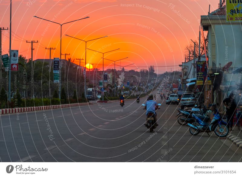Pakse main road in sunset, Laos Shopping Beautiful Vacation & Travel Summer Sun Lamp Culture Nature Landscape Sky Tree Hill Town Architecture Transport Street