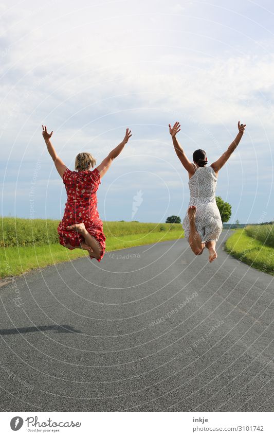 two women jump high rear view Lifestyle Joy Happy Summer Human being Feminine Young woman Youth (Young adults) Woman Adults Friendship Couple Partner 2