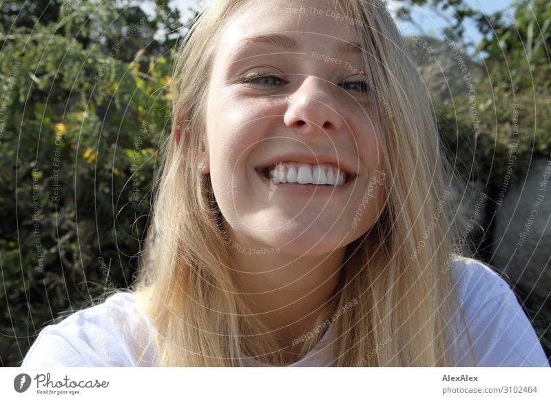 Very close portrait of a young blonde woman smiling cheekily into the camera Lifestyle Joy pretty Wellness Summer Summer vacation Sunbathing Young woman