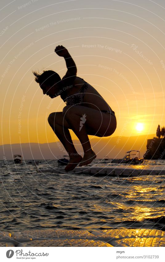 Silhouette of woman before sunset jumping into the water Jump Water Lake bathing fun bathe Swimming & Bathing Summer Sun Sunset Joie de vivre (Vitality)