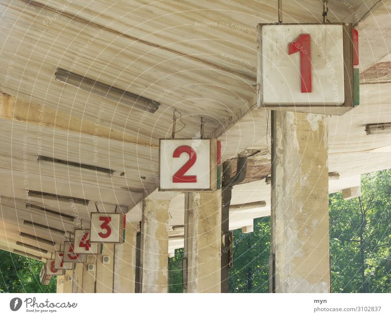Platform numbers at bus station Numbers Numbers and numbers Digits and numbers Signs and labeling Concrete Colour photo Wall (building) Deserted Gray Old Facade