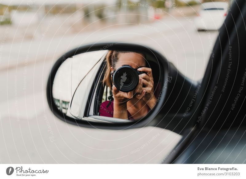 young woman taking a photo from a rear view mirror of a car. Travel and Lifestyle outdoors Rear view mirror Joy Car Vacation & Travel Transport Stern Trip Woman