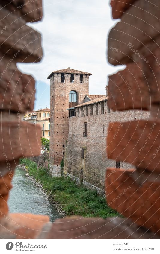 Scenic view of a tower of the medieval Castelvecchio castle in Verona, Italy verona italy wall ancient bricks red middle ages chain castelvecchio architecture