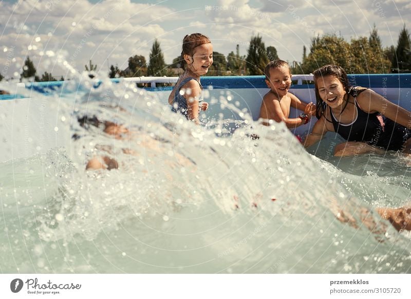 Children splashing in a pool Lifestyle Joy Happy Relaxation Swimming pool Playing Vacation & Travel Summer Summer vacation Human being Girl Boy (child)