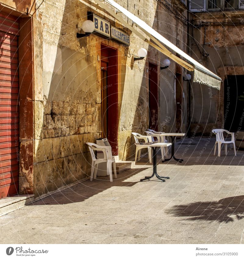 siesta Summer Beautiful weather Apulia Village Small Town Deserted Marketplace Facade Rolling door Sit Wait Simple Cliche Yellow Red Hospitality Calm Loneliness