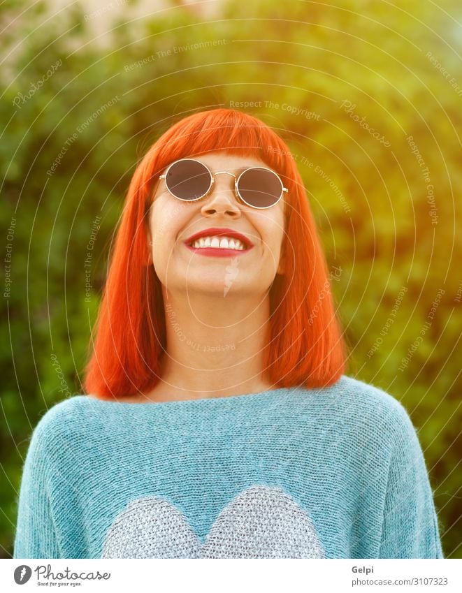 Red haired woman looking up in a park enjoying her free time Lifestyle Style Joy Happy Beautiful Relaxation Leisure and hobbies Vacation & Travel Human being