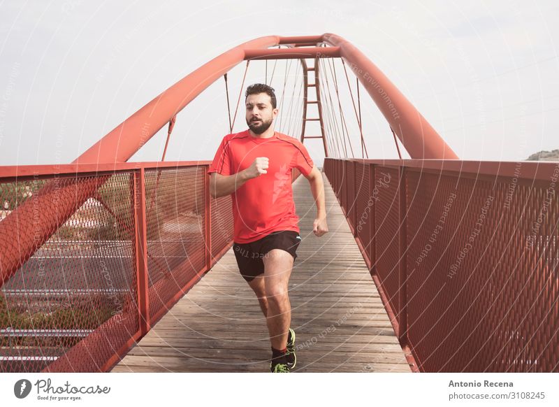 Bearded mid adult man running Lifestyle Sports Human being Man Adults Bridge Pedestrian Shirt Red Effort 30s mid adult person sprint level crossing bearded
