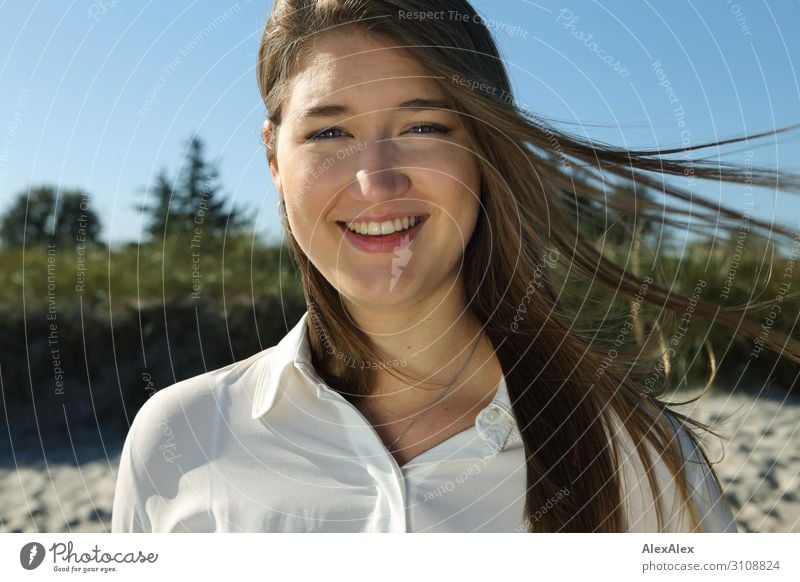 Portrait of a young woman in front of a dune Joy already Life Well-being Summer Summer vacation Sun Beach Beach dune Young woman Youth (Young adults) Face