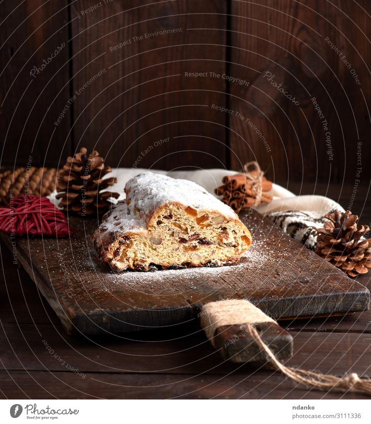 Stollen baked a traditional European cake Fruit Bread Cake Dessert Herbs and spices Winter Table Feasts & Celebrations Wood Delicious Brown White Tradition