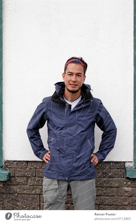 Man with bandana and rain jacket and open expression in front of white wall Hiking Masculine Young man Youth (Young adults) Adults 1 Human being 30 - 45 years