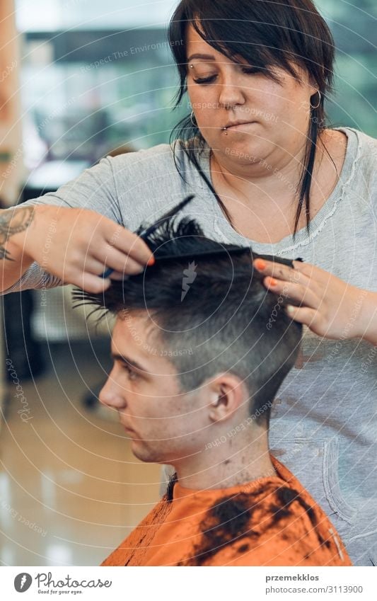 Hairdresser is haircutting styling young mans hair Lifestyle Shopping Style Hair and hairstyles Work and employment Profession Scissors Woman Adults Man 2