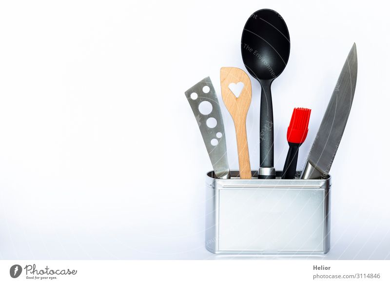 Cooking utensils in a metal can Knives Spoon Design Kitchen Wood Metal Plastic Brown Red Black Silver White Still Life Background picture Neutral Background