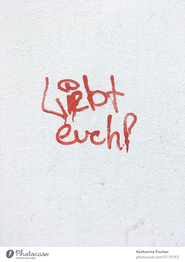Love each other! Town Wall (barrier) Wall (building) Sign Characters Graffiti Letters (alphabet) Text Punctuation mark Exclamation mark Red White Stone wall