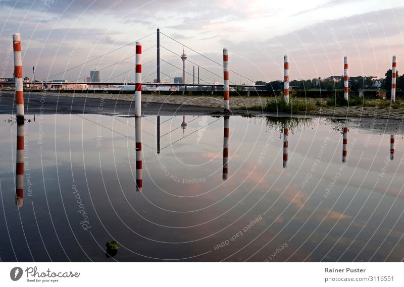The skyline of Düsseldorf is reflected in a large puddle after the rain Sky Clouds Sunrise Sunset Duesseldorf Downtown Skyline Bridge Tower Landmark