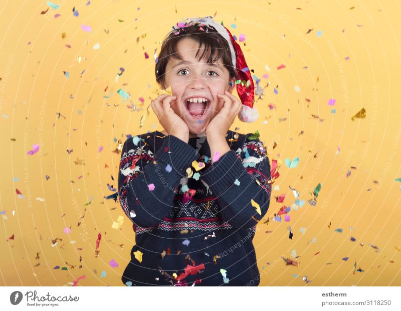 smiling child with confetti Wearing Christmas Santa Claus Hat Joy Happy Winter Feasts & Celebrations Christmas & Advent New Year's Eve Human being Masculine