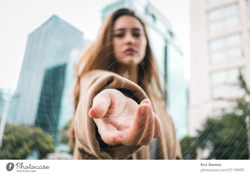 Young woman with hand gesturing towards camera Human being Feminine Youth (Young adults) Hand Fingers 1 18 - 30 years Adults Town Capital city Building