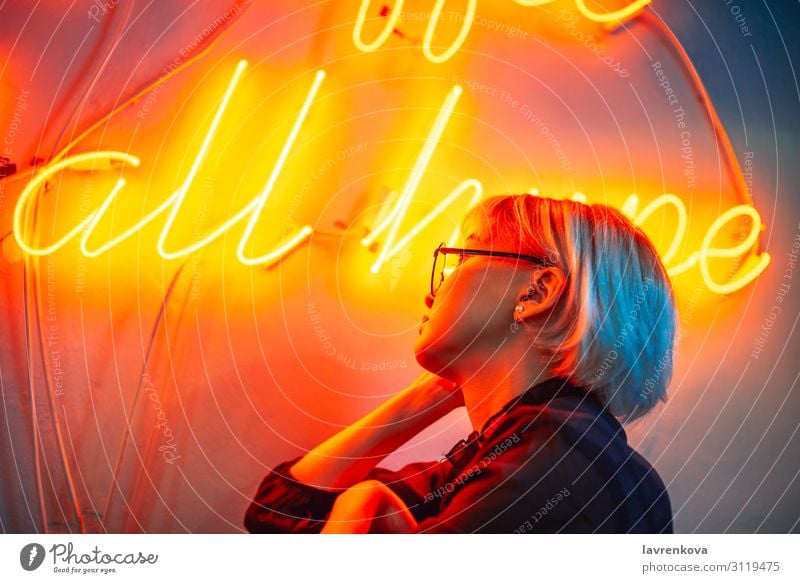 Female wearing glasses in front of neon light sign Asians Blonde Eyeglasses Woman Young woman Girl Lighting Neon light Night life Orange Portrait photograph Red