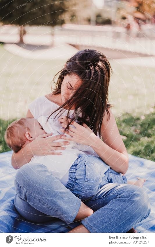young mother breast feeding her baby girl outdoors in a park - a Royalty  Free Stock Photo from Photocase