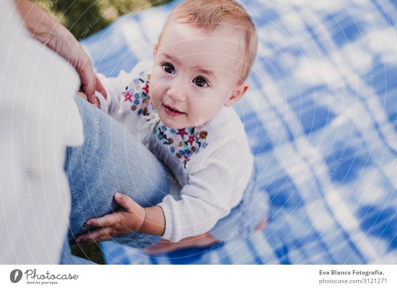 young mother playing with baby girl outdoors in a park Lifestyle Joy Happy Beautiful Playing Summer Sun Parenting Child Human being Feminine Baby Young woman