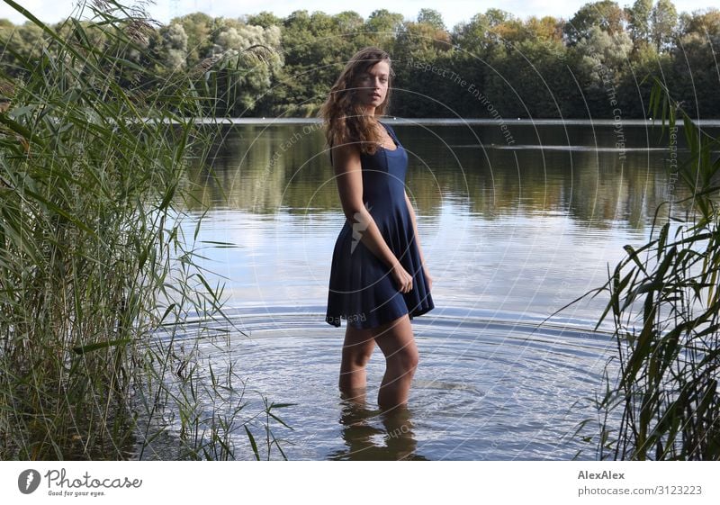 Portrait of a young, tall woman standing in an idyllic lake Lifestyle Style already Wellness Trip Adventure Summer vacation Young woman Youth (Young adults)