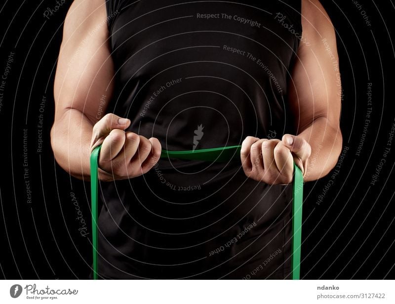 athlete with a muscular body in black clothes Lifestyle Body Athletic Fitness Sports Sportsperson Human being Man Adults Arm Hand Band Muscular Strong Green