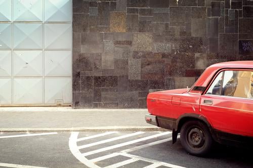 red car Town Capital city House (Residential Structure) Wall (barrier) Wall (building) Facade Street Vehicle Car Retro Trashy Red Gate Parking Budapest