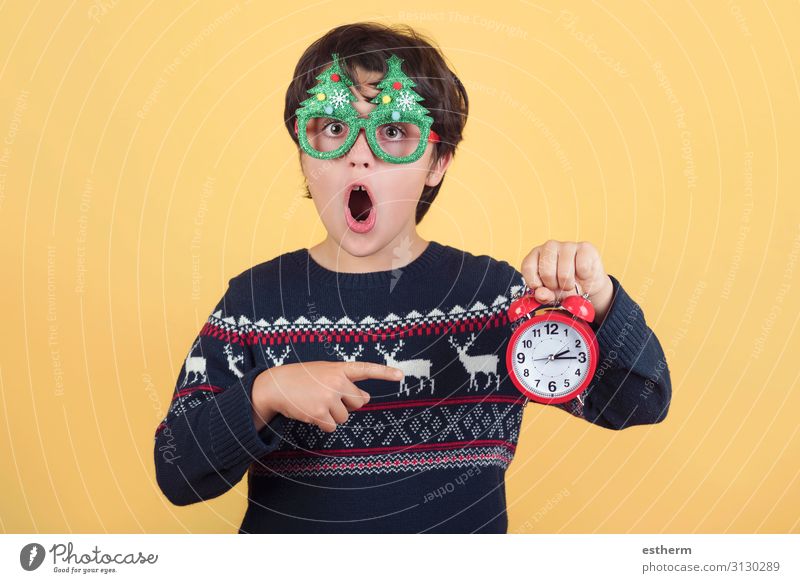 Surprised child with alarm clock Wearing Funny Christmas glasses Joy Winter Clock Feasts & Celebrations Christmas & Advent New Year's Eve Human being Masculine