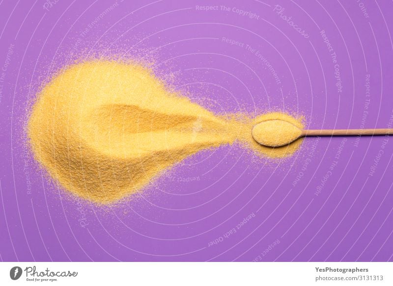 Corn flour pile and a spoon on purple background - a Royalty Free Stock ...