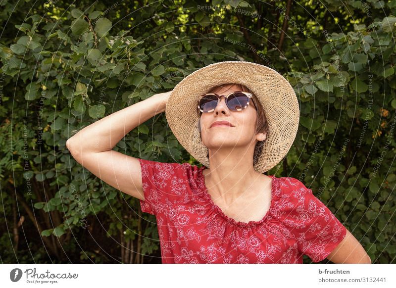 Woman with sun hat Lifestyle Style Well-being Leisure and hobbies Adults Face Hand 1 Human being Summer Bushes Dress Sunglasses Hat Relaxation To hold on