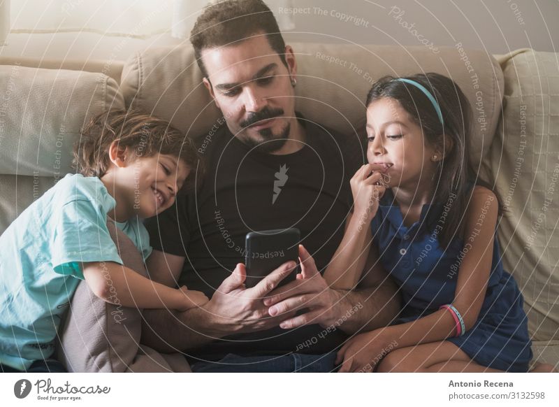father phone Lifestyle Sofa Living room Child Telephone PDA Human being Boy (child) Man Adults Father Family & Relations Infancy Love Sit Together Modern