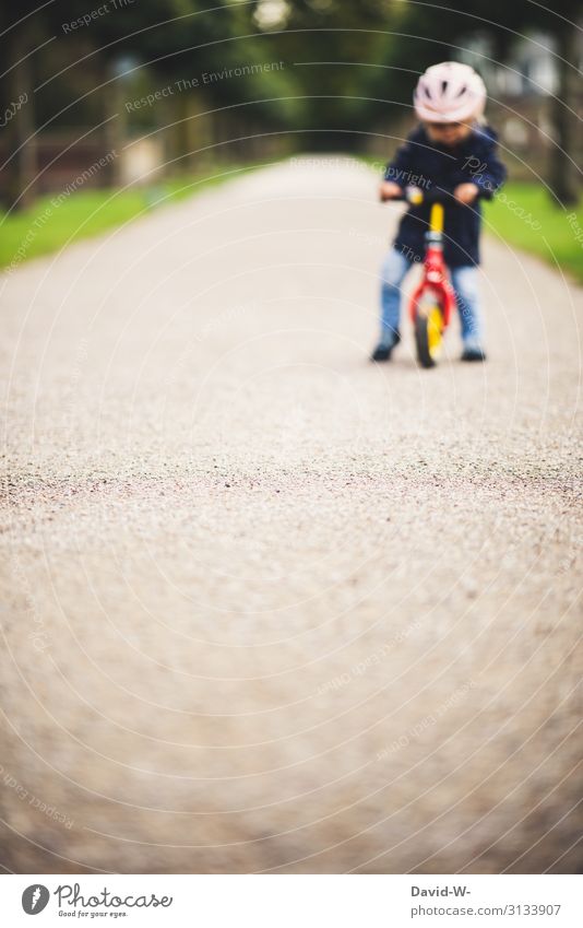 Child on the road with the bike Bicycle Kiddy bike Bike helmet Safety Deep depth of field Lanes & trails off Driving Cycling Study Practice Practice Practice