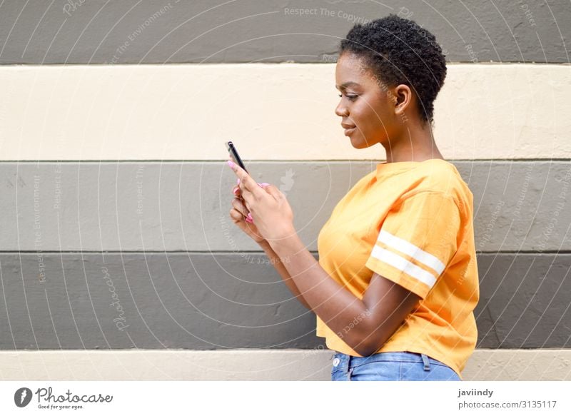 Young black woman using her smart phone outdoors. Lifestyle Style Happy Hair and hairstyles Telephone Cellphone PDA Technology Internet Human being Feminine
