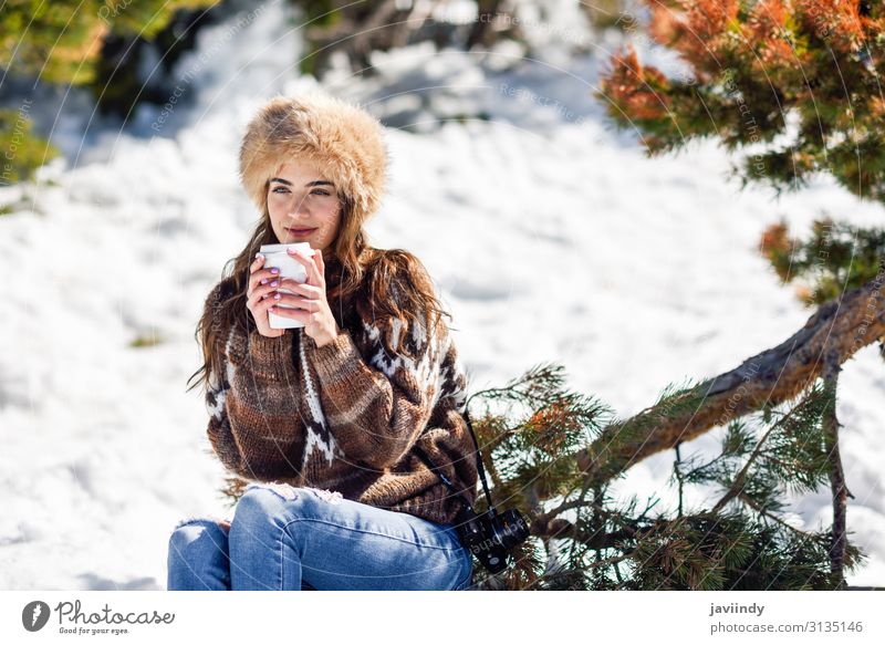 Young woman enjoying the snowy mountains in winter Coffee Tea Lifestyle Elegant Happy Beautiful Face Leisure and hobbies Winter Snow Mountain Human being
