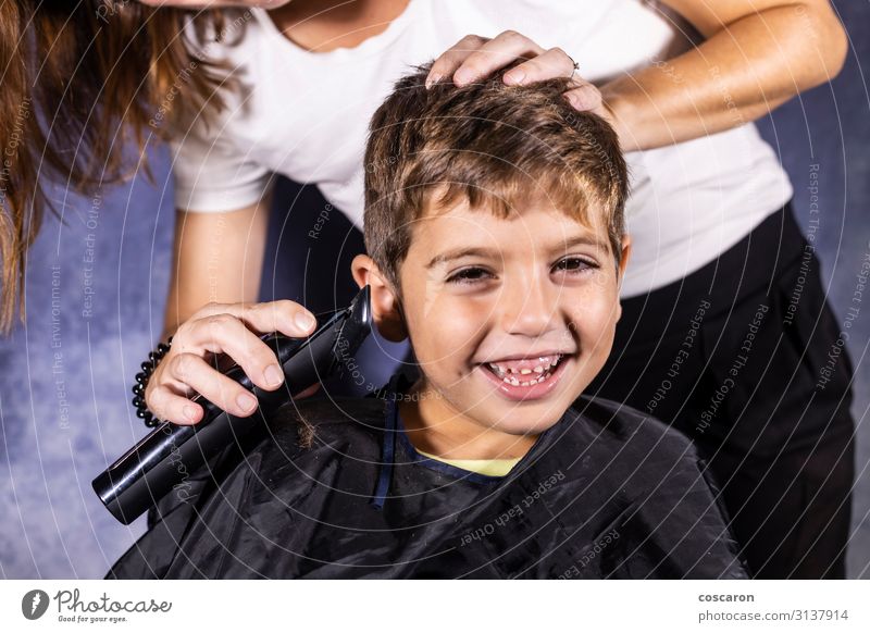 Little boy getting a haircut with a cutting machine Lifestyle Shopping Style Beautiful Hair and hairstyles Face Playing Child Profession Hairdresser Business